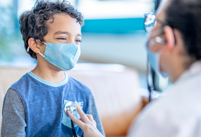 Little boy wearing mask visiting doctor